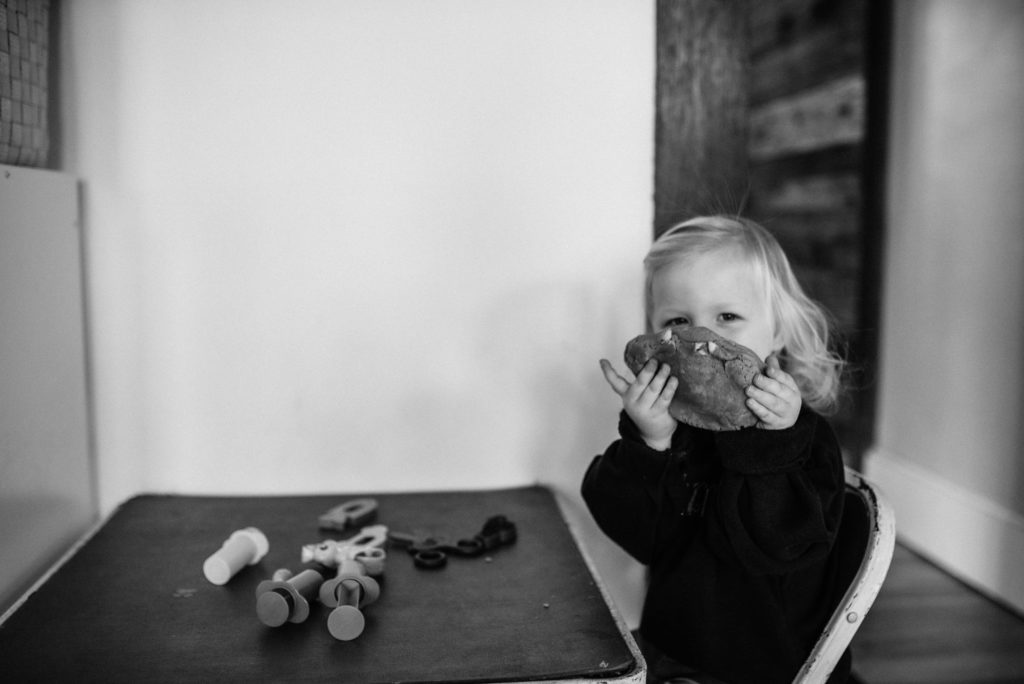 toddler girl eating playdough
