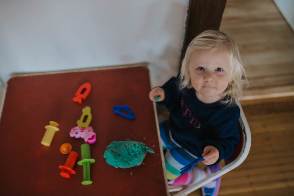toddler girl playing with play dough